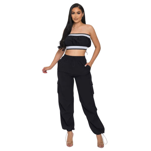 Woman wearing a black and white outfit with cargo pants on a white background
